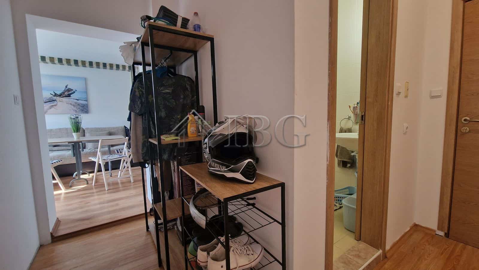 Interior of a 1-bedroom apartment with pool view, showing hallway and living area.