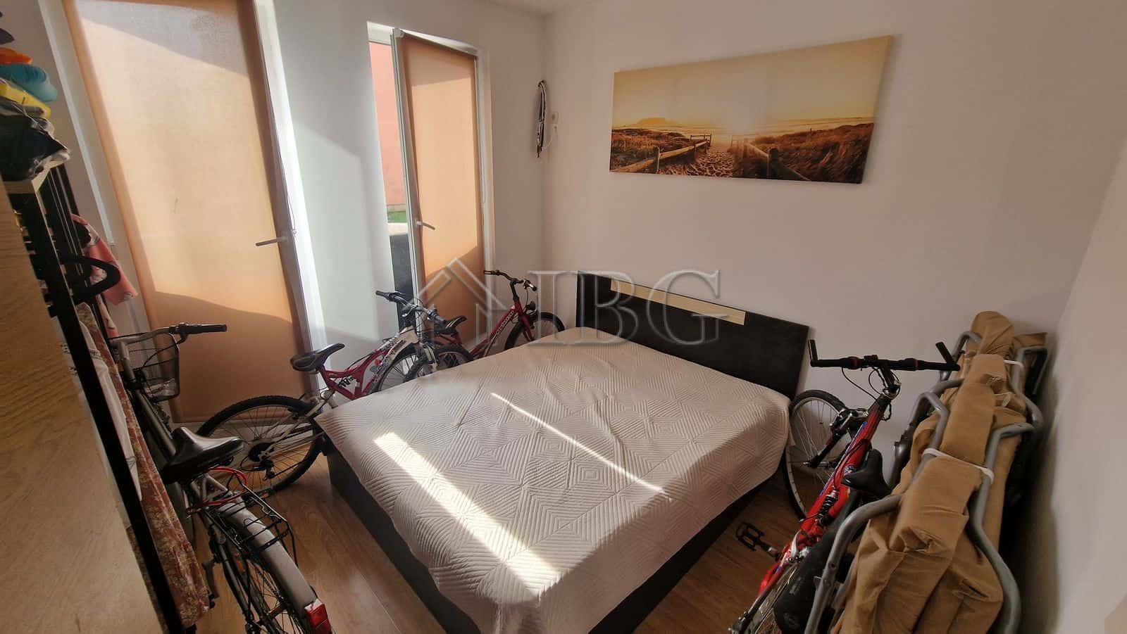 Cozy bedroom with bicycles and balcony view in Sunny Beach area.