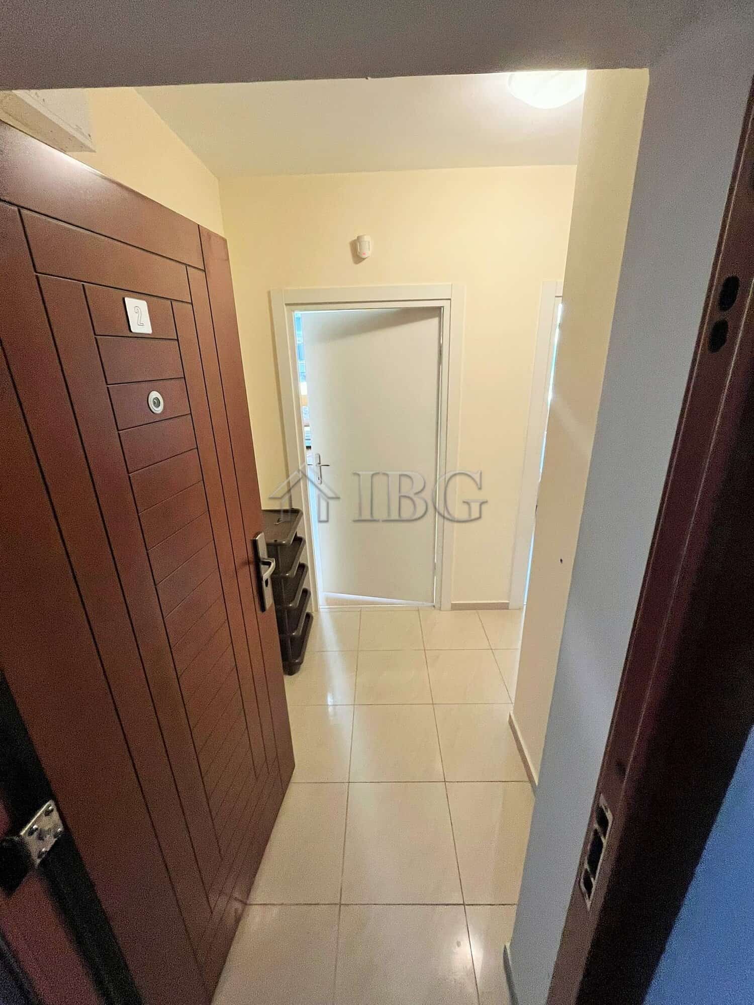Furnished 1-Bedroom Apartment Near Cacao Beach Apartment entrance with wooden wardrobe and hallway view.