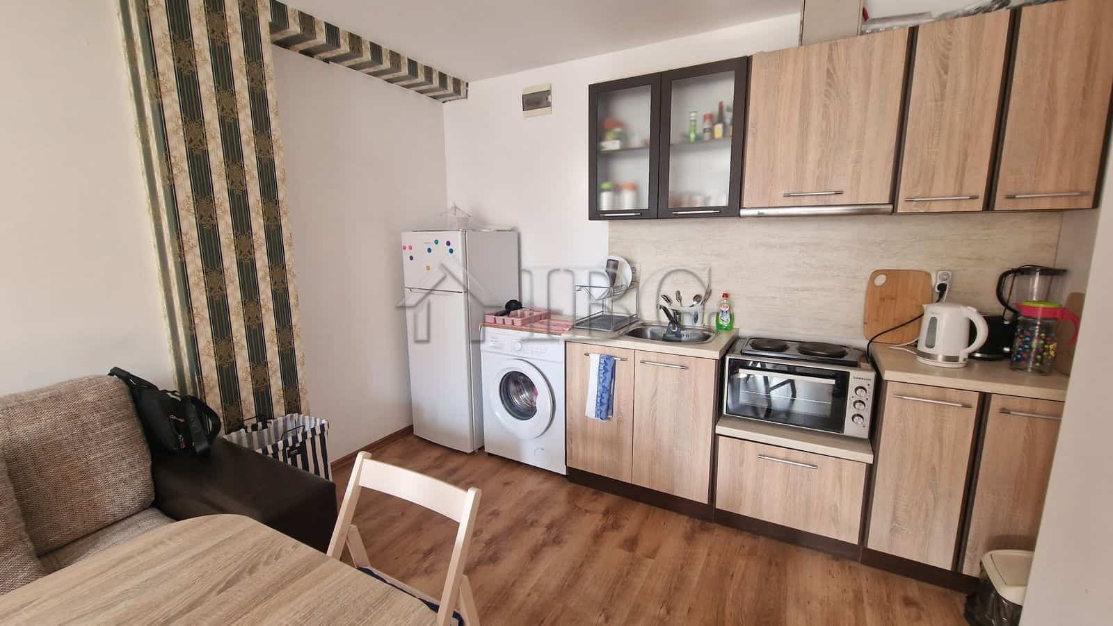 Interior of a 1-bedroom apartment with kitchen and pool view in Sunny Beach area.