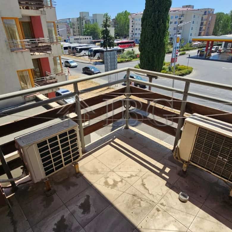 Balcony of a Sunny Beach apartment featuring air conditioning units and a view of the cityscape and.