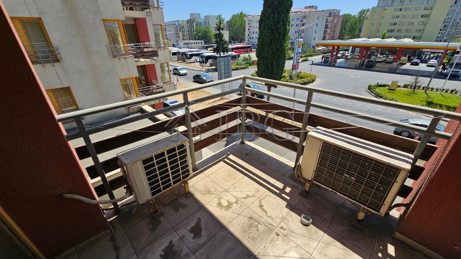Balcony of a Sunny Beach apartment featuring air conditioning units and a view of the cityscape and.