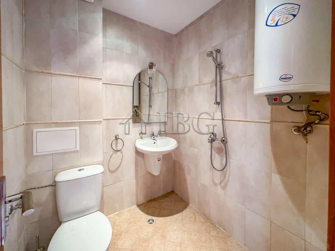 Bathroom with shower, toilet, and water heater in a Sveti Vlas apartment.