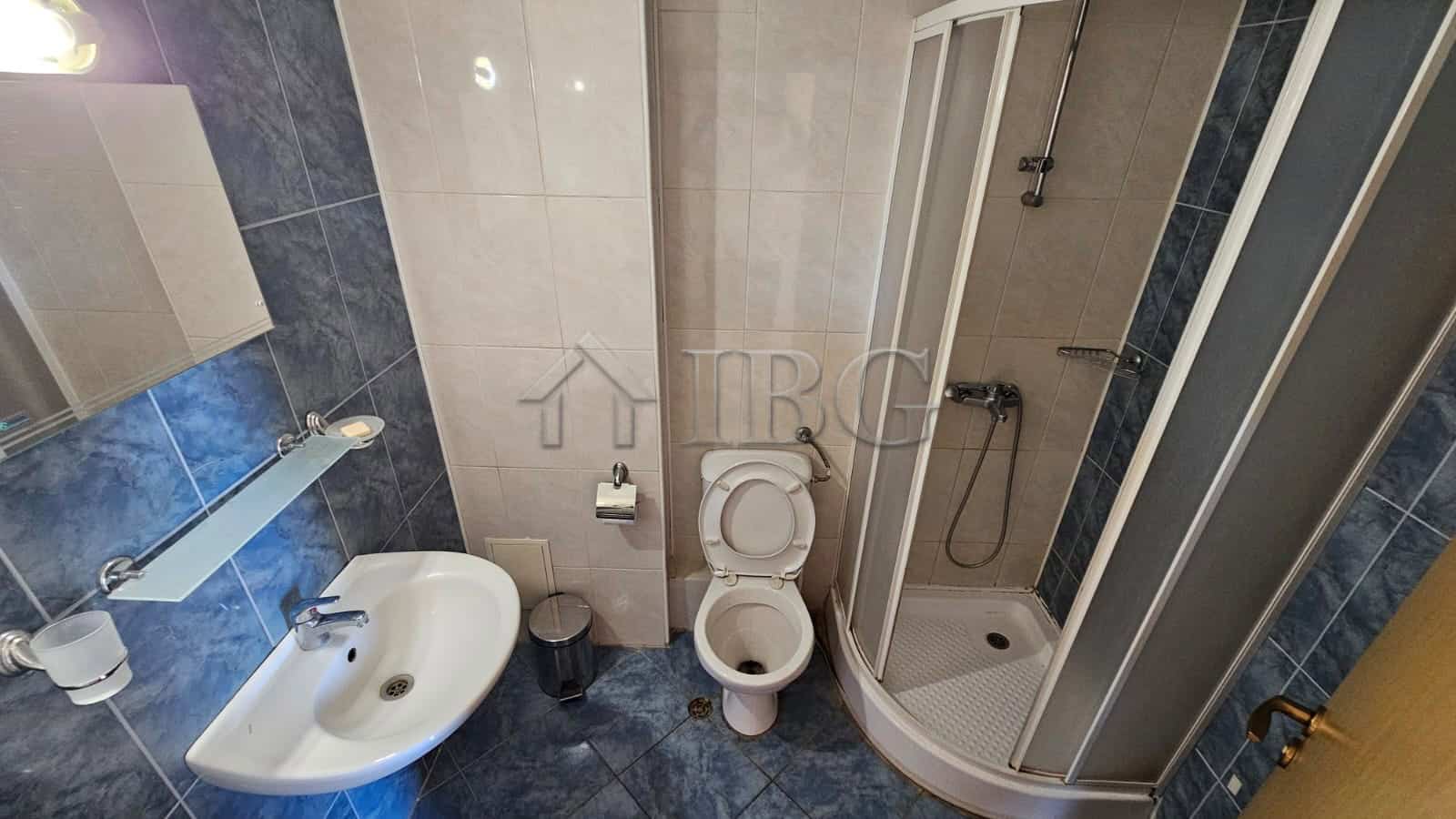Bathroom with shower, toilet, and sink at Tria Apartments, Sunny Beach.