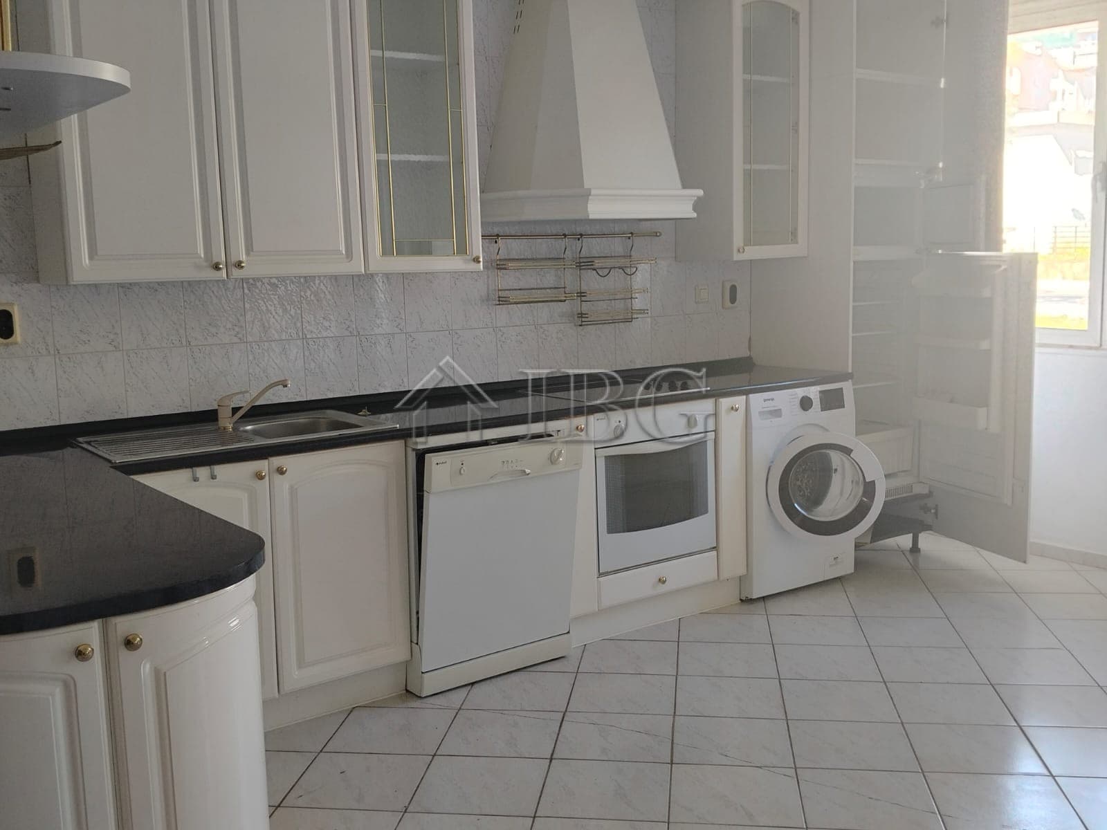 White kitchen with appliances and panoramic sea views in Sveti Vlas.
