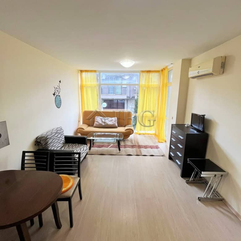 Apartment with living room, sofa, dining table, and TV in Sunny Beach.