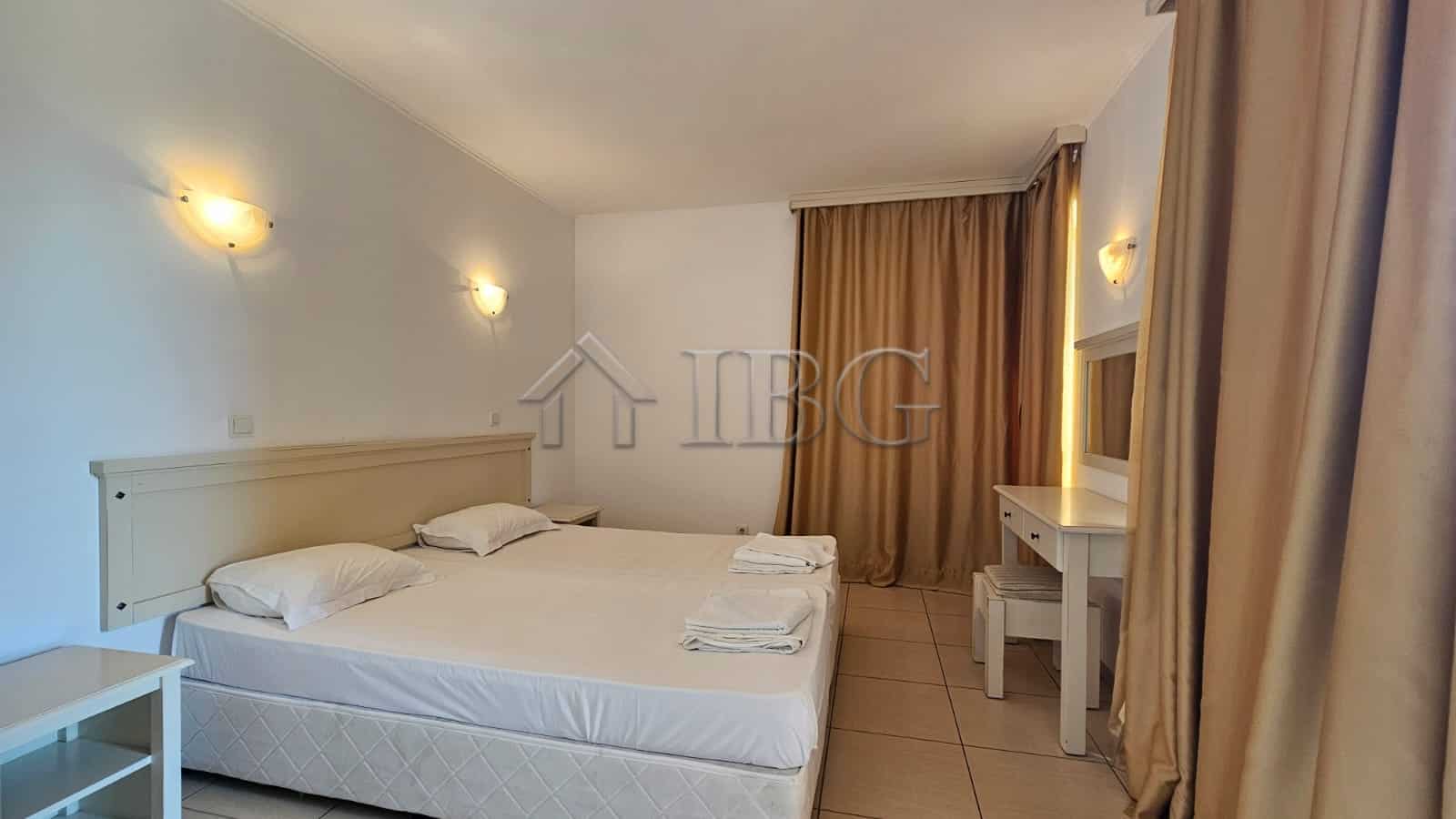 Bright interior of a no-maintenance fee apartment in Sunny Beach, Bulgaria, featuring a spacious bed.