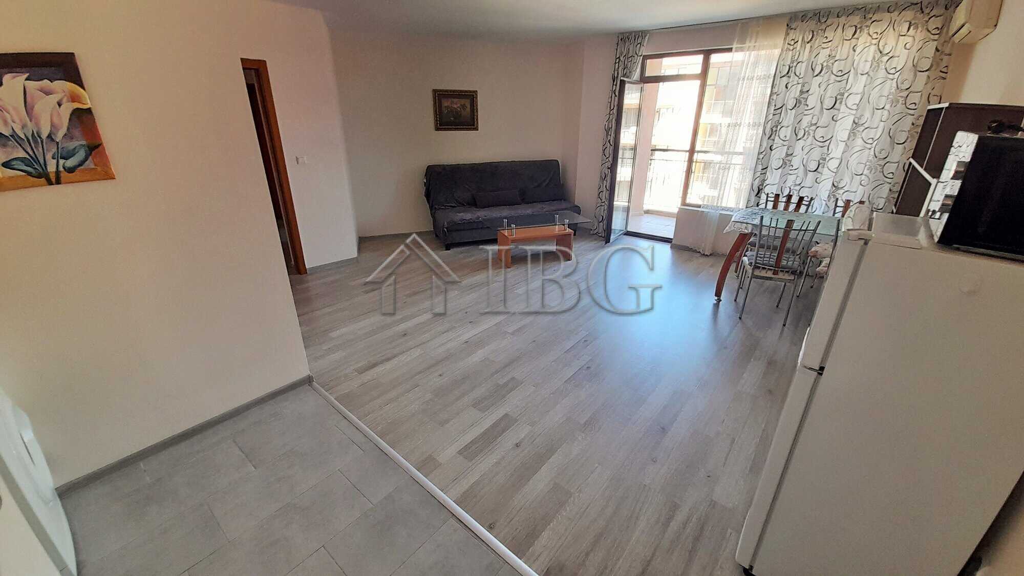 Bright living room with pool view in Sea Grace complex, Sunny Beach. Modern furnishings and spacious.