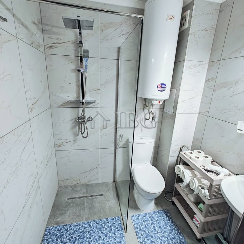 Compact studio with separate kitchen, balcony, and modern bathroom near the sea.