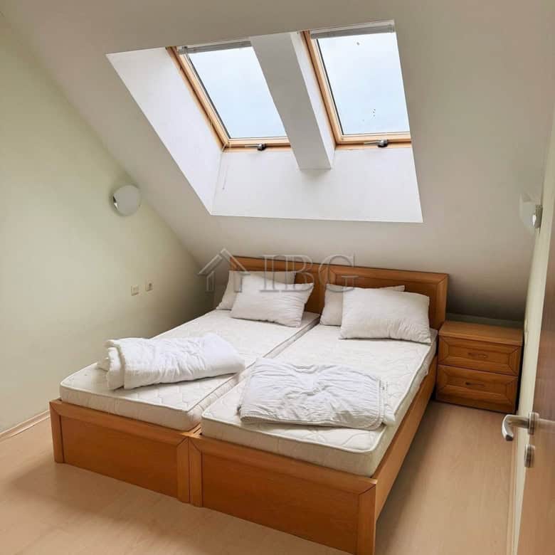 Bright bedroom with skylight windows overlooking the pool at Pollo Resort, Sunny Beach. Perfect for.