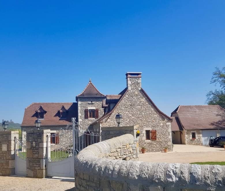 Le Manoir house for sale in Dordogne Valley, France, featuring four bedrooms and historic stone arch.