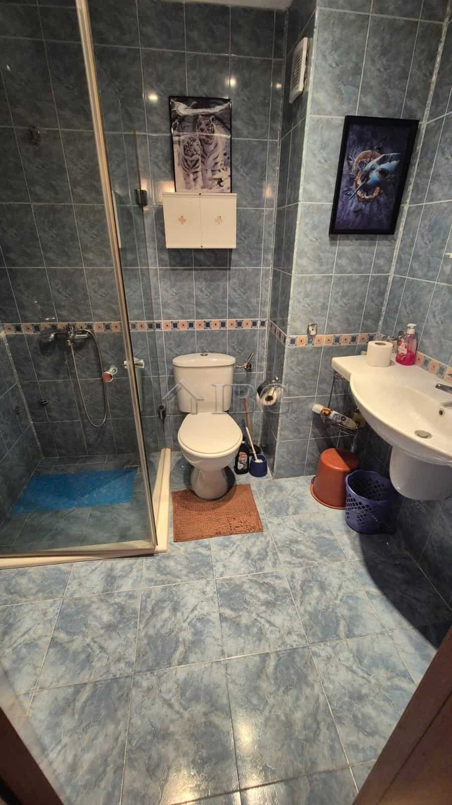 Bathroom with shower, toilet, and sink in a 1-bedroom apartment at Semiramida Gardens.