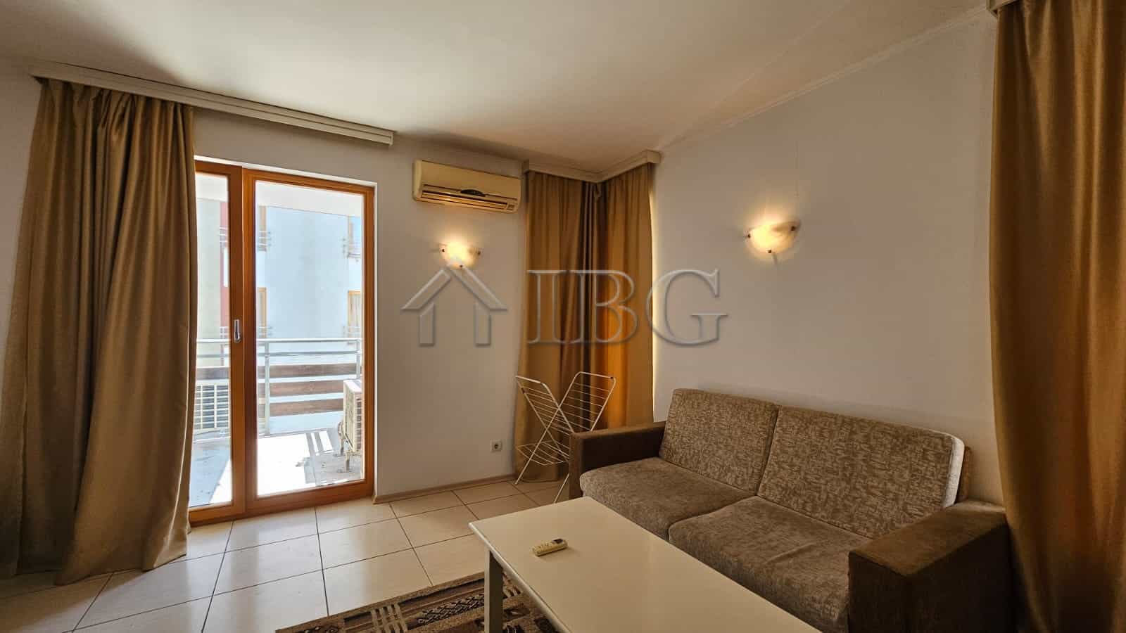 Bright living room with balcony access in Tria Apartments, Sunny Beach.