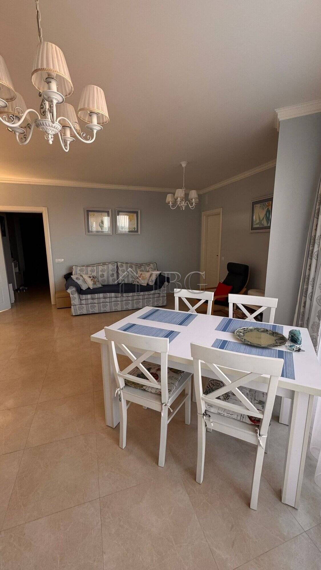 Bright living room with dining area, sea and mountain view in Sveti Vlas apartment.