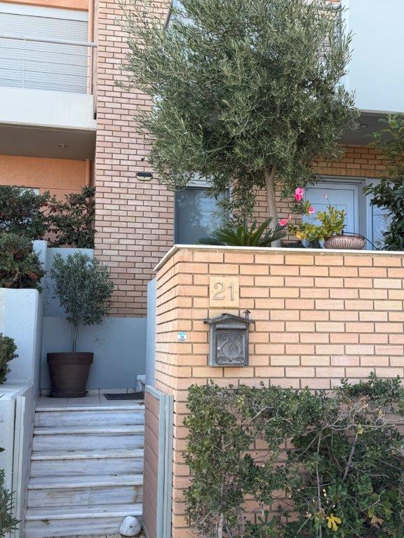 Luxury 3-bedroom home for sale in Neos Voutzas, Attica, Greece, featuring modern design and lush gar.