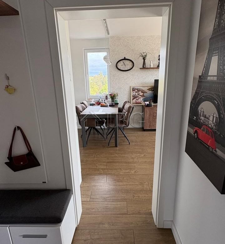 Bright apartment view through doorway showing dining table and living space in Pomorie Residence.