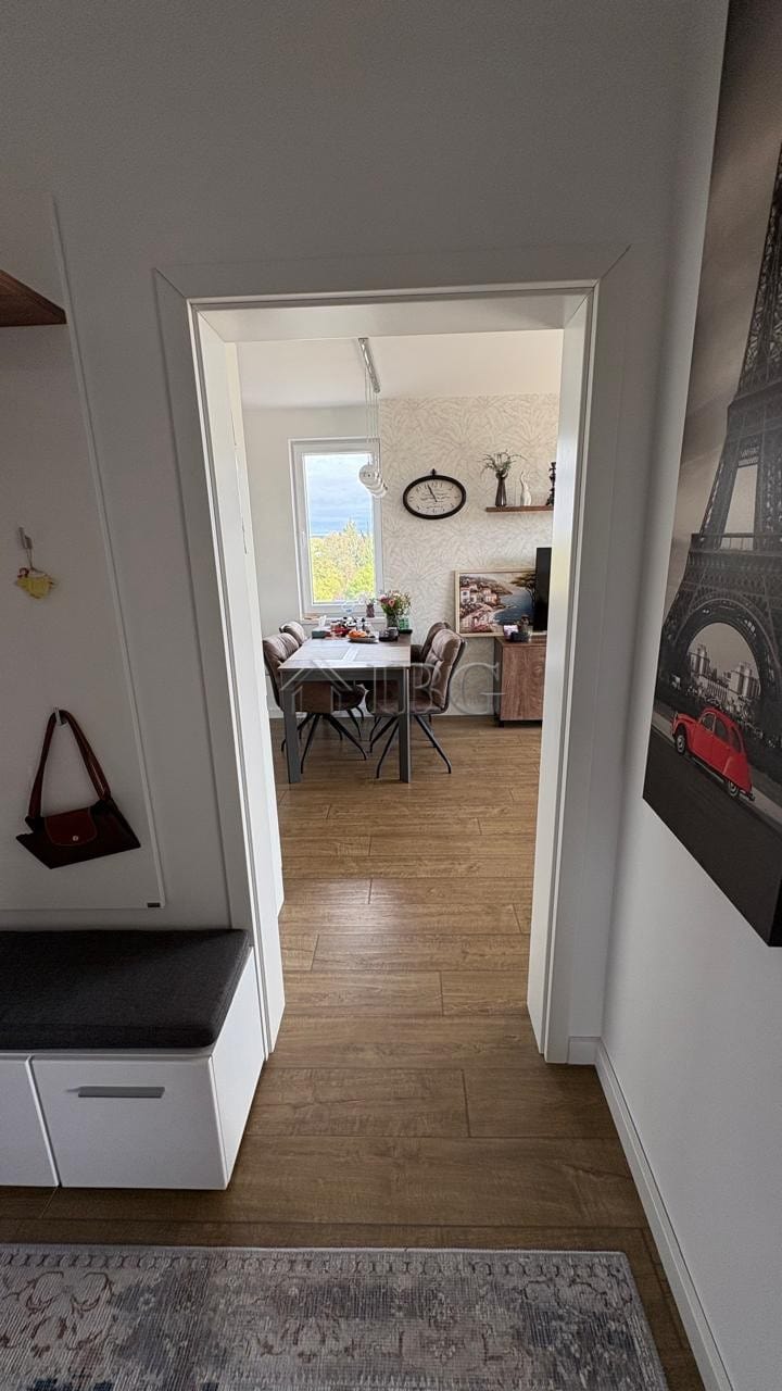 Bright apartment view through doorway showing dining table and living space in Pomorie Residence.