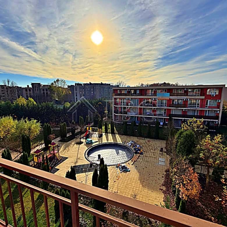 Bright pool view from sunny beach studio balcony.