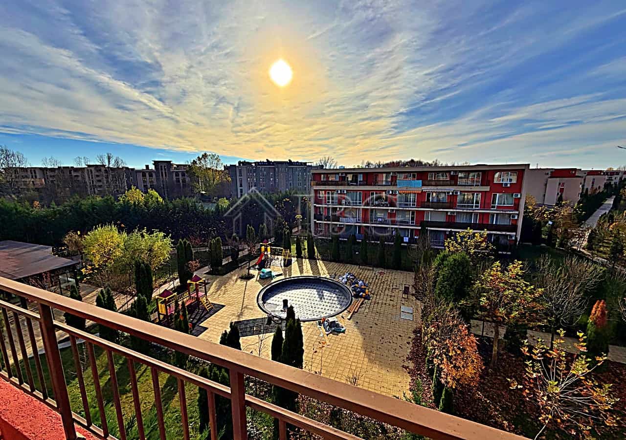Bright pool view from sunny beach studio balcony.