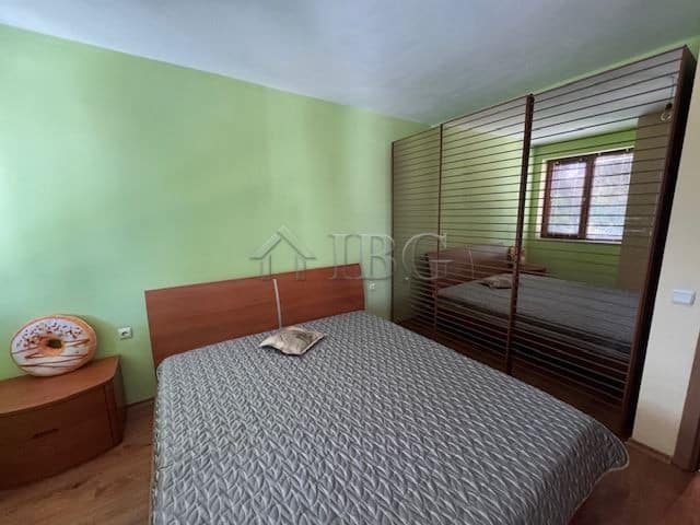 Bright bedroom with a large wardrobe and modern decor. Perfect for comfortable living in Vazrazhdane.
