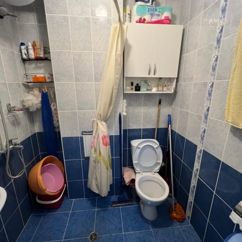 Bathroom with toilet, shower, and storage in a one-bedroom maisonette at Global Villa, Sunny Beach.