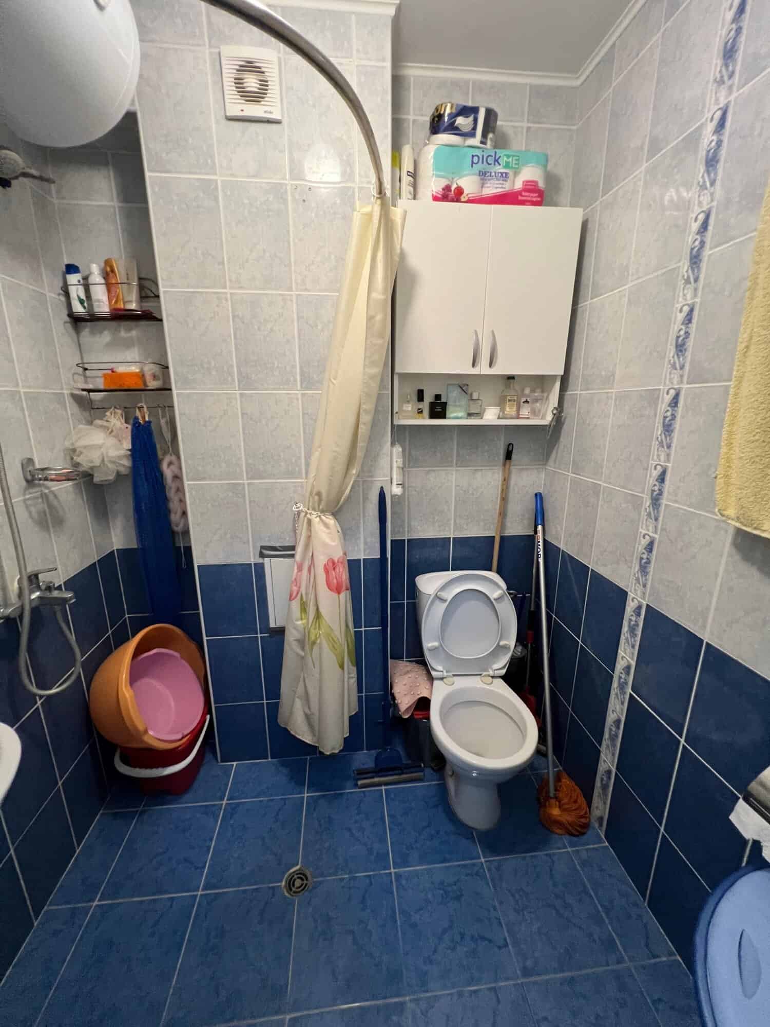 Bathroom with toilet, shower, and storage in a one-bedroom maisonette at Global Villa, Sunny Beach.