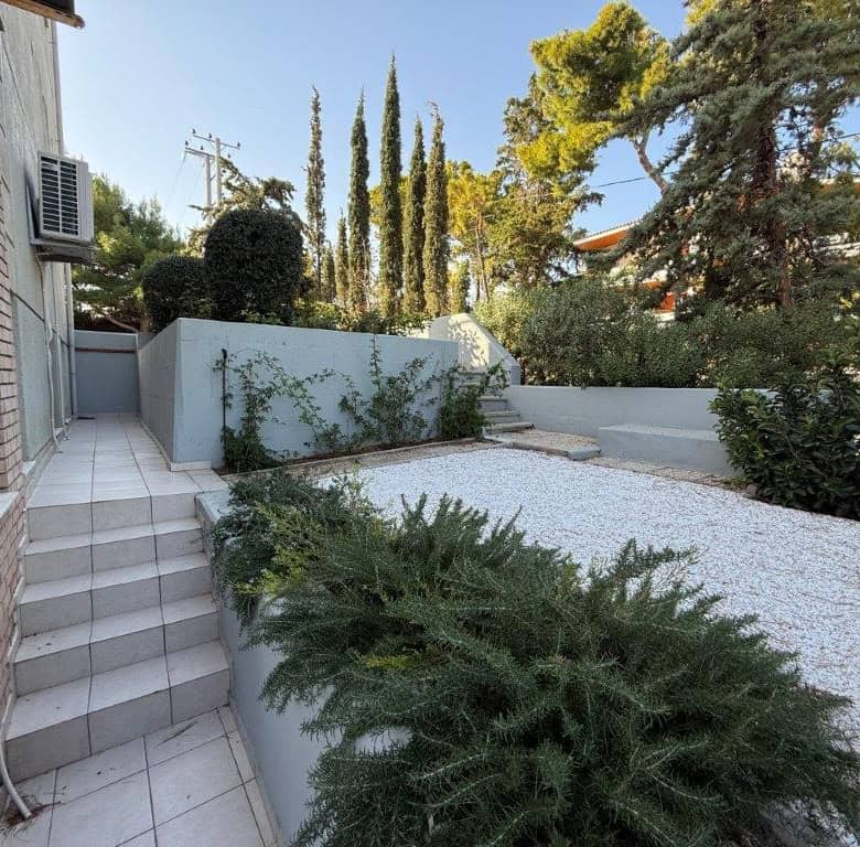 Luxury 3-bedroom home for sale in Neos Voutzas, Attica, Greece, featuring a landscaped garden and mo.