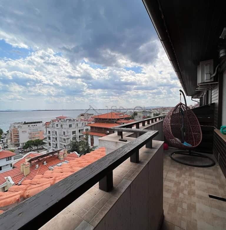 Balcony with stunning sea views in Sveti Vlas, Bulgaria, featuring modern outdoor furniture and a sc.