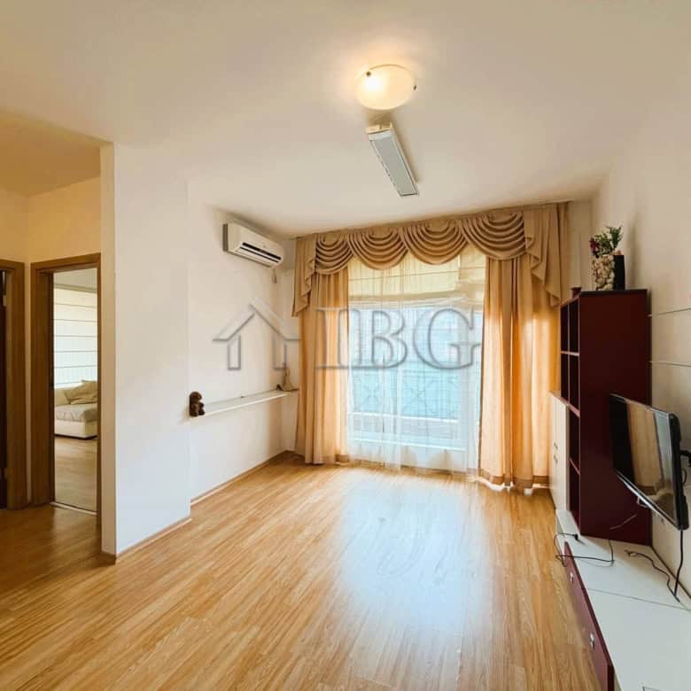 Bright 2-bedroom apartment overlooking park and tennis court, sunny day, ideal for comfortable livin.