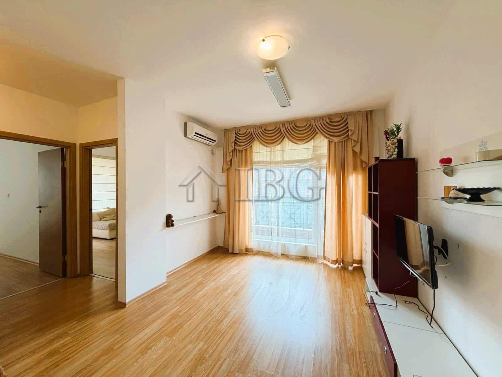 Bright 2-bedroom apartment overlooking park and tennis court, sunny day, ideal for comfortable livin.