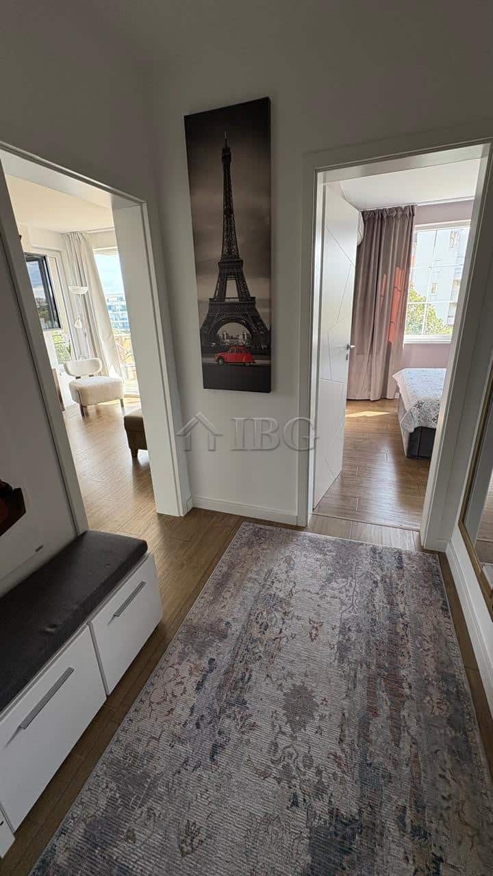 Bright entrance hall with Paris-themed artwork and access to bedrooms.