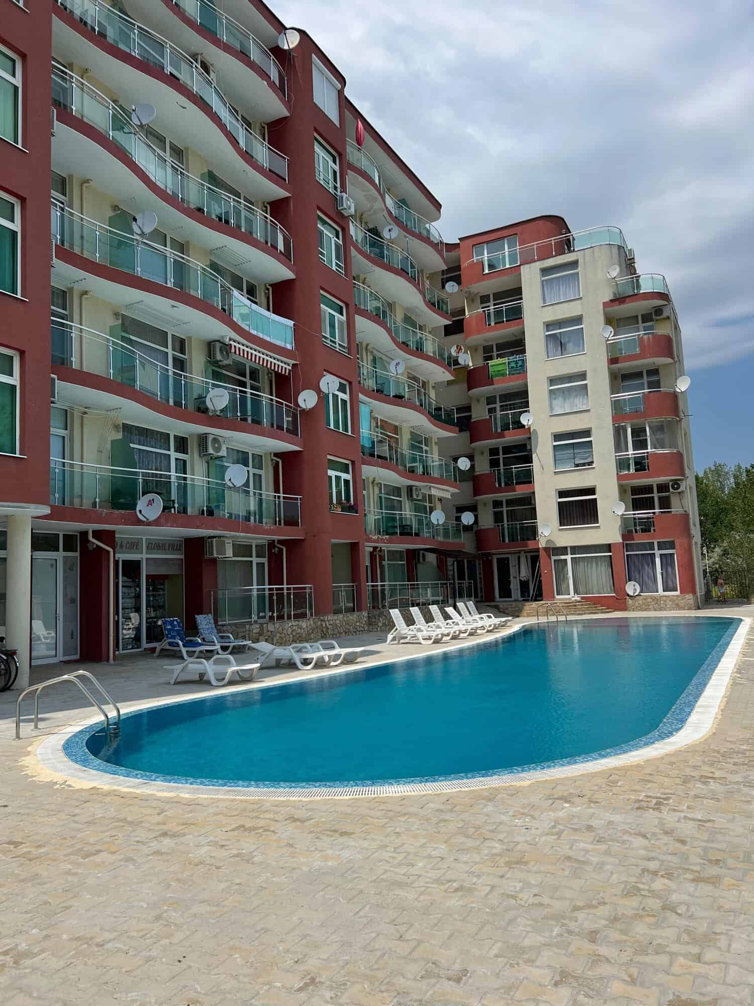 Apartment building with pool and balconies in Sunny Beach, Bulgaria.