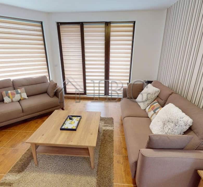 Bright living room with two sofas and large windows in Bay View Villas, Kosharitsa.
