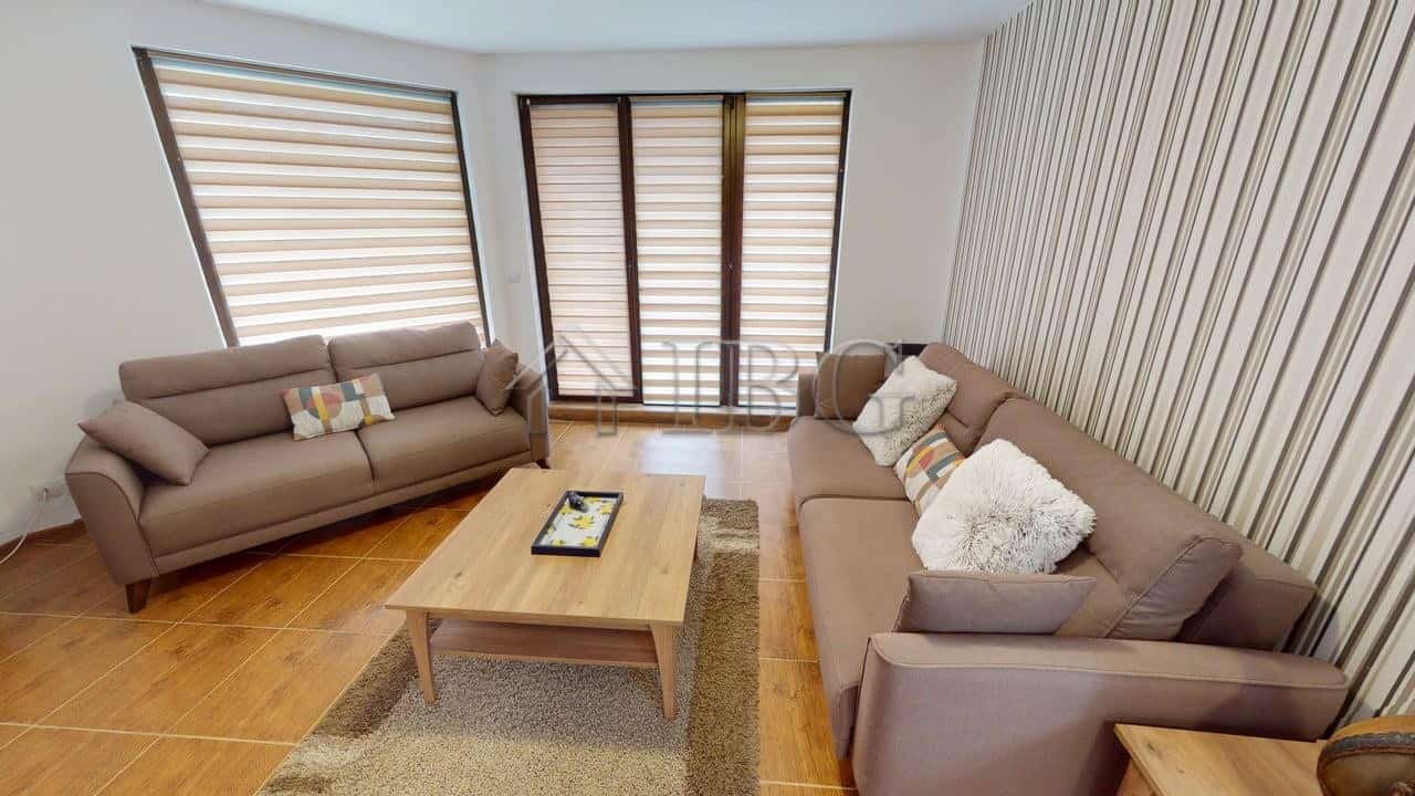 Bright living room with two sofas and large windows in Bay View Villas, Kosharitsa.