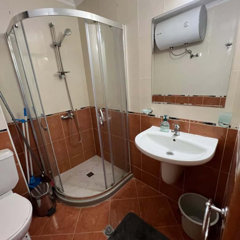 Bathroom with shower cabin, sink, and toilet in Sveti Vlas property.