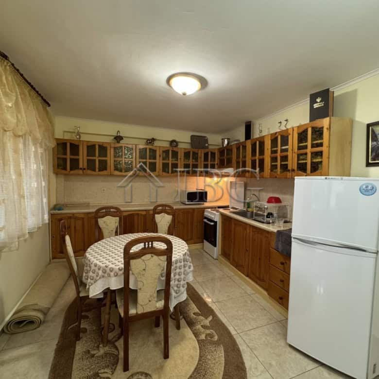 Bright kitchen with wooden cabinets and dining area.