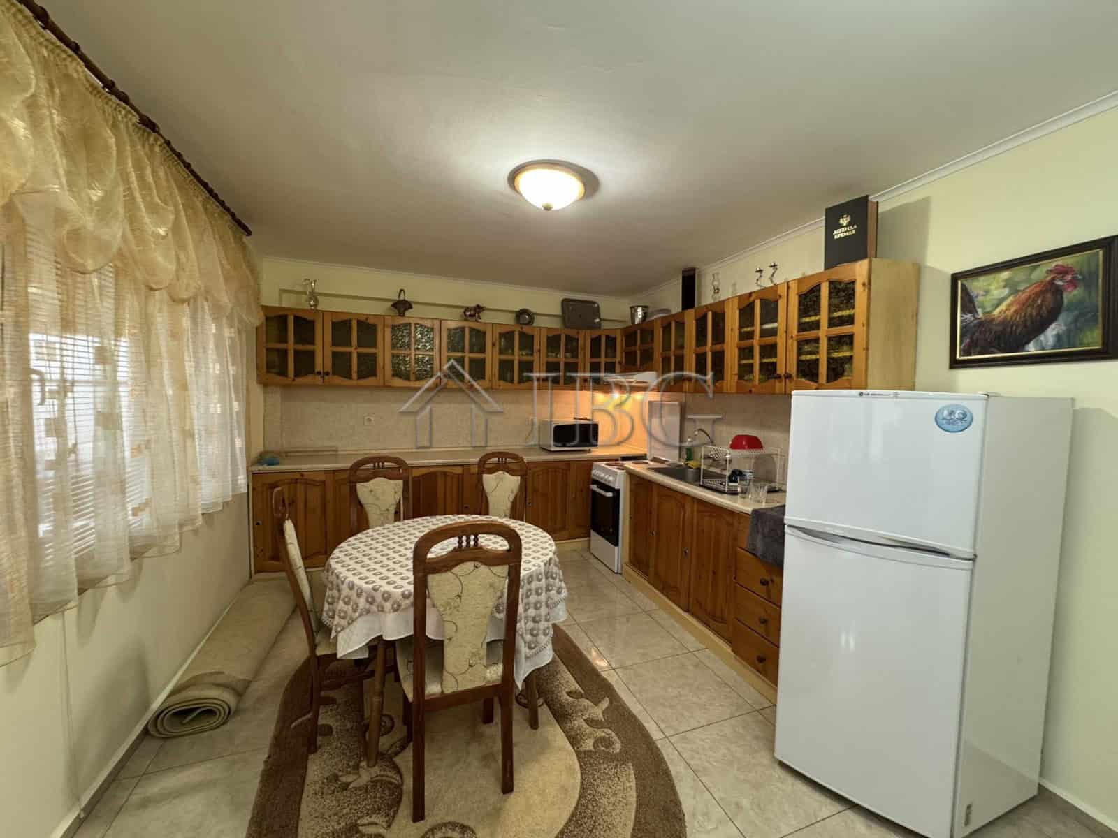 Bright kitchen with wooden cabinets and dining area.