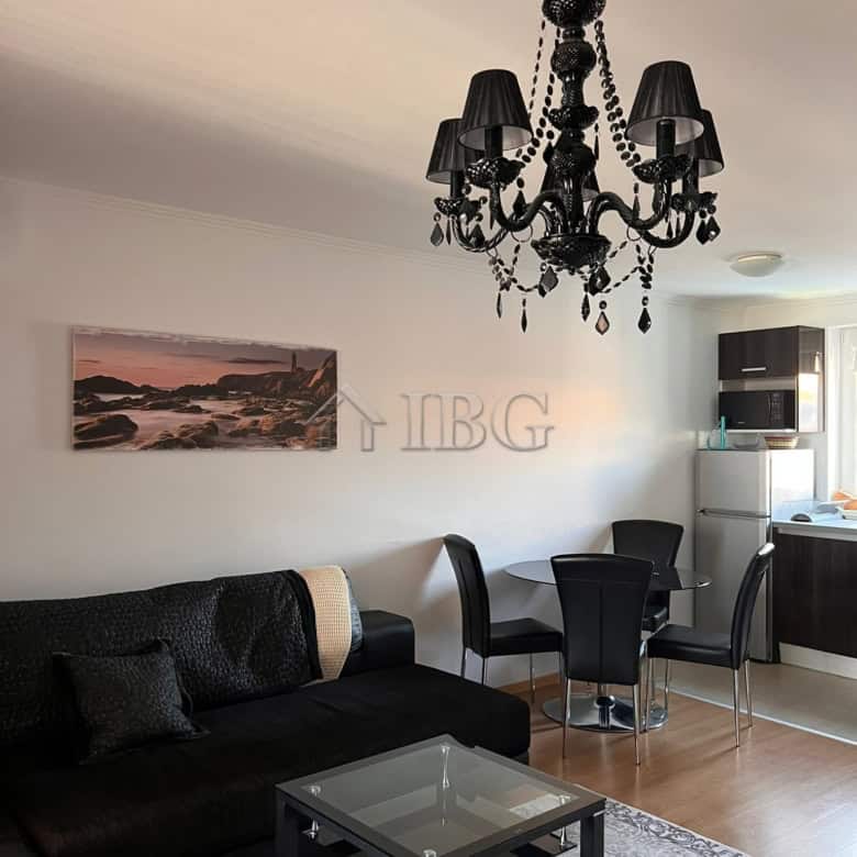 Stylish living room featuring a black chandelier, comfortable sofa, and contemporary furniture in a.