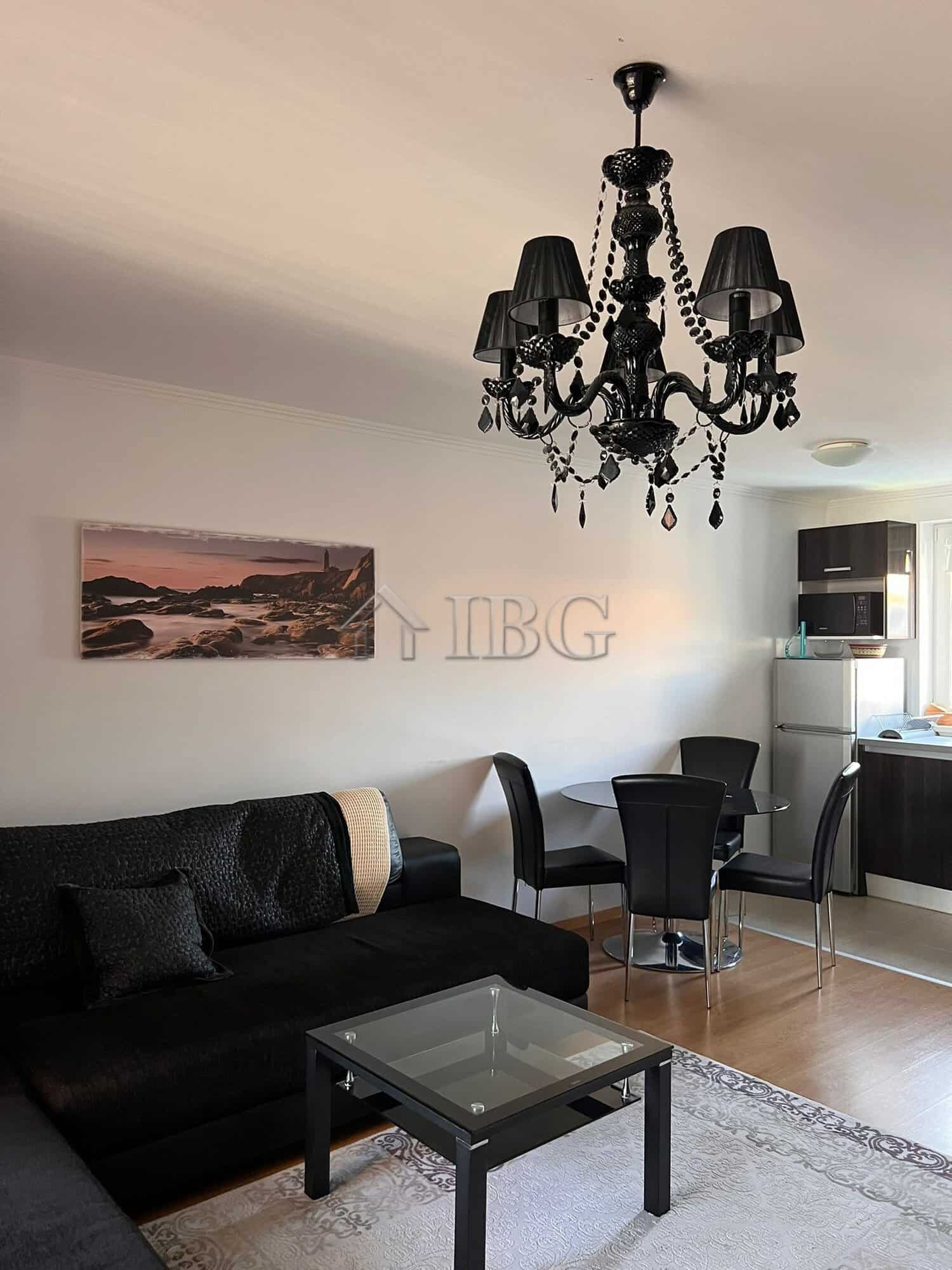 Stylish living room featuring a black chandelier, comfortable sofa, and contemporary furniture in a.