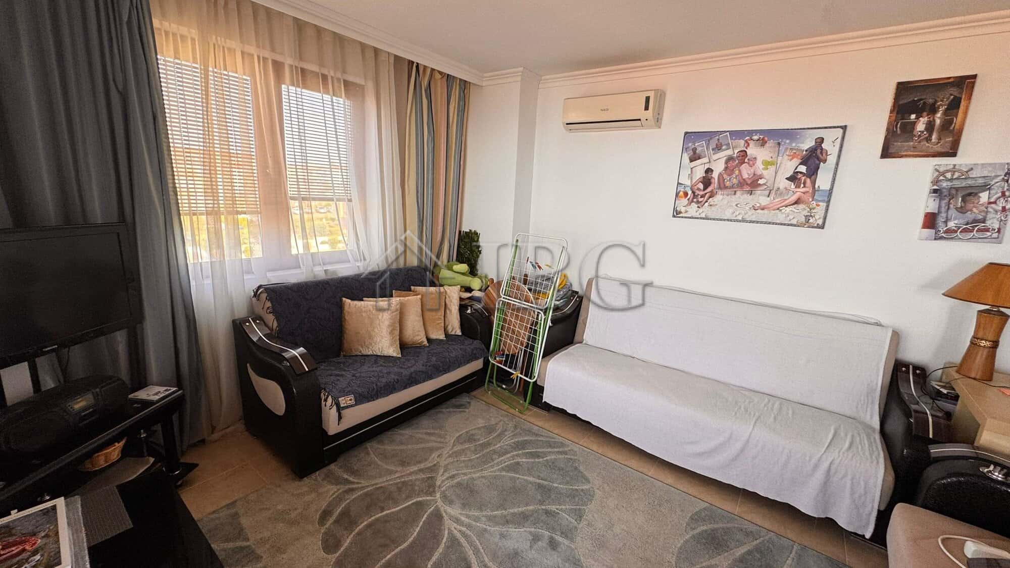 Interior of a two-bedroom apartment with sea view in Sveti Vlas, featuring a living room with sofa a.