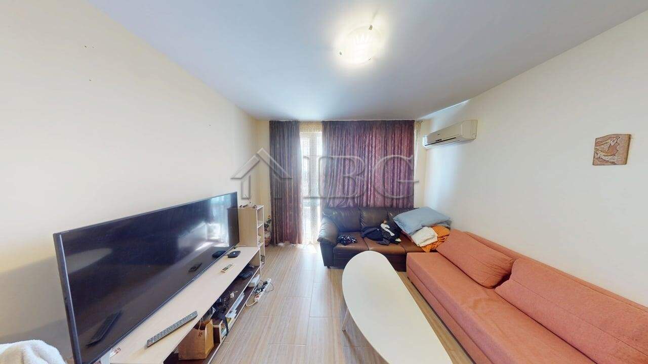 Interior of a 1-bedroom apartment with pool view in Kosharitsa, Bulgaria.