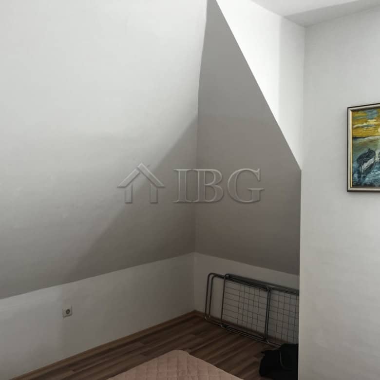 Interior of a 1-bedroom apartment with sea view, white walls, and artwork in Ravda.