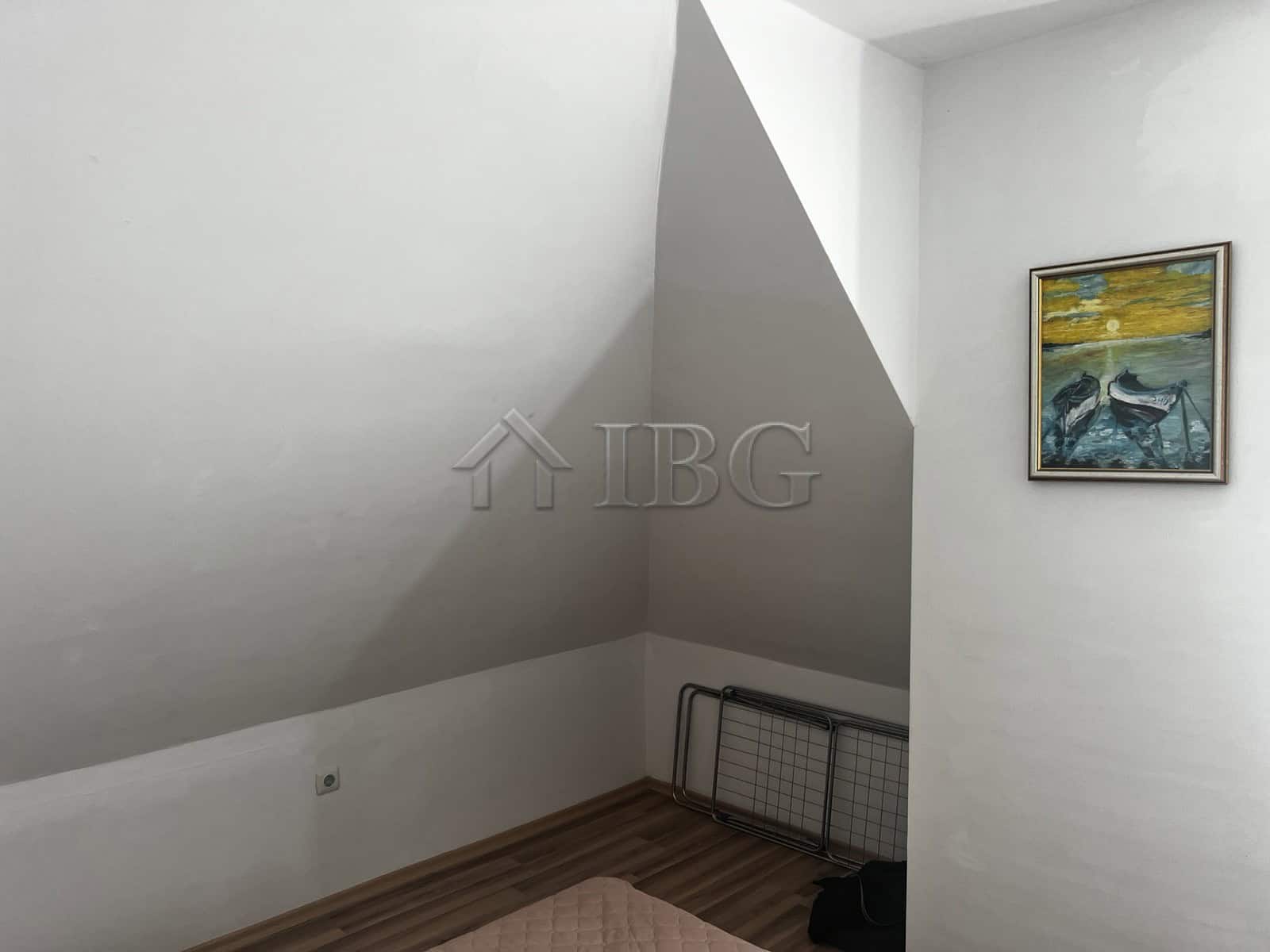 Interior of a 1-bedroom apartment with sea view, white walls, and artwork in Ravda.
