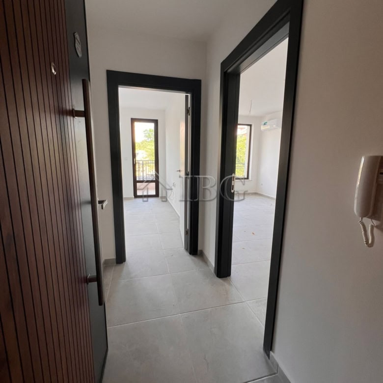 Bright hallway in a modern Sveti Vlas apartment with large windows and open living space.