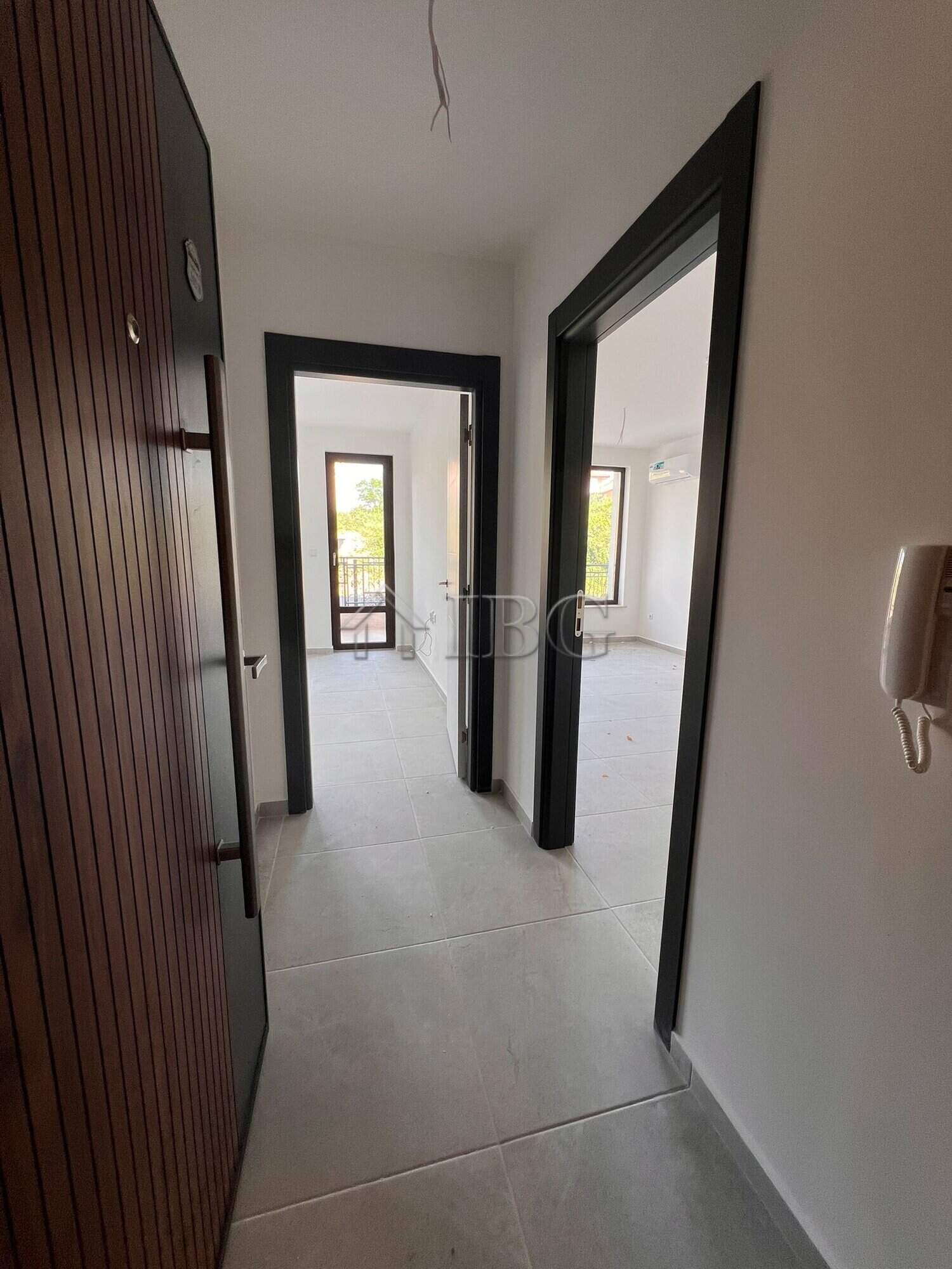 Bright hallway in a modern Sveti Vlas apartment with large windows and open living space.
