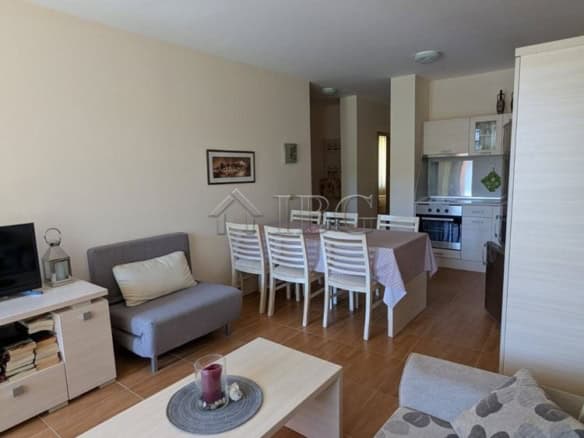 Bright living room in Sveti Vlas apartment with pool view and modern furnishings.