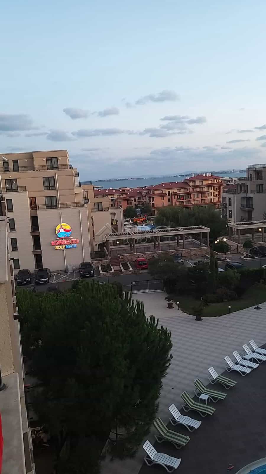 Sea and pool view from a one-bedroom apartment in Sveti Vlas, Luxor, showcasing modern buildings and.