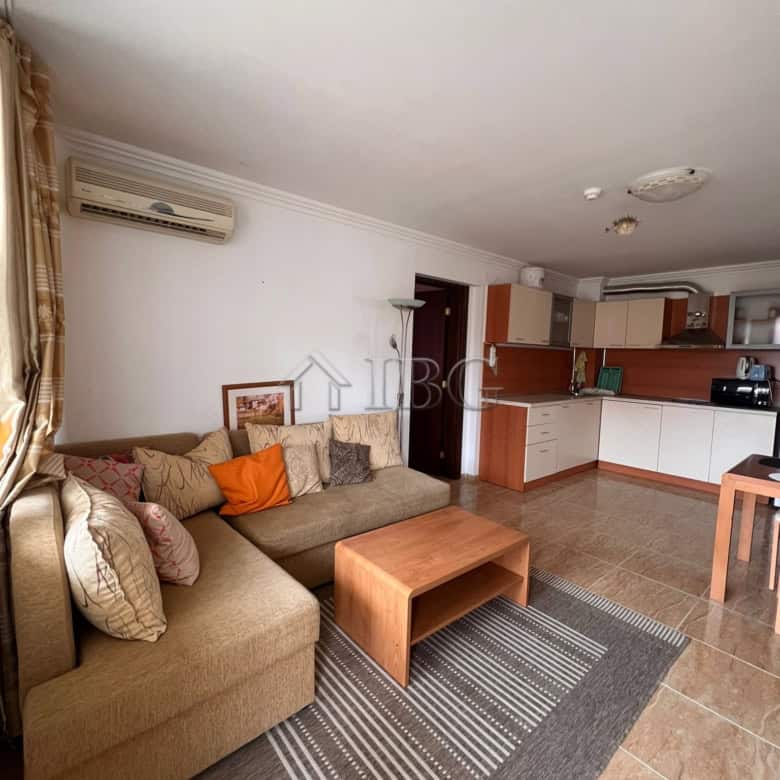 Spacious living area with sofa, cushions, and modern kitchen in Kambani 3 complex, Sveti Vlas.