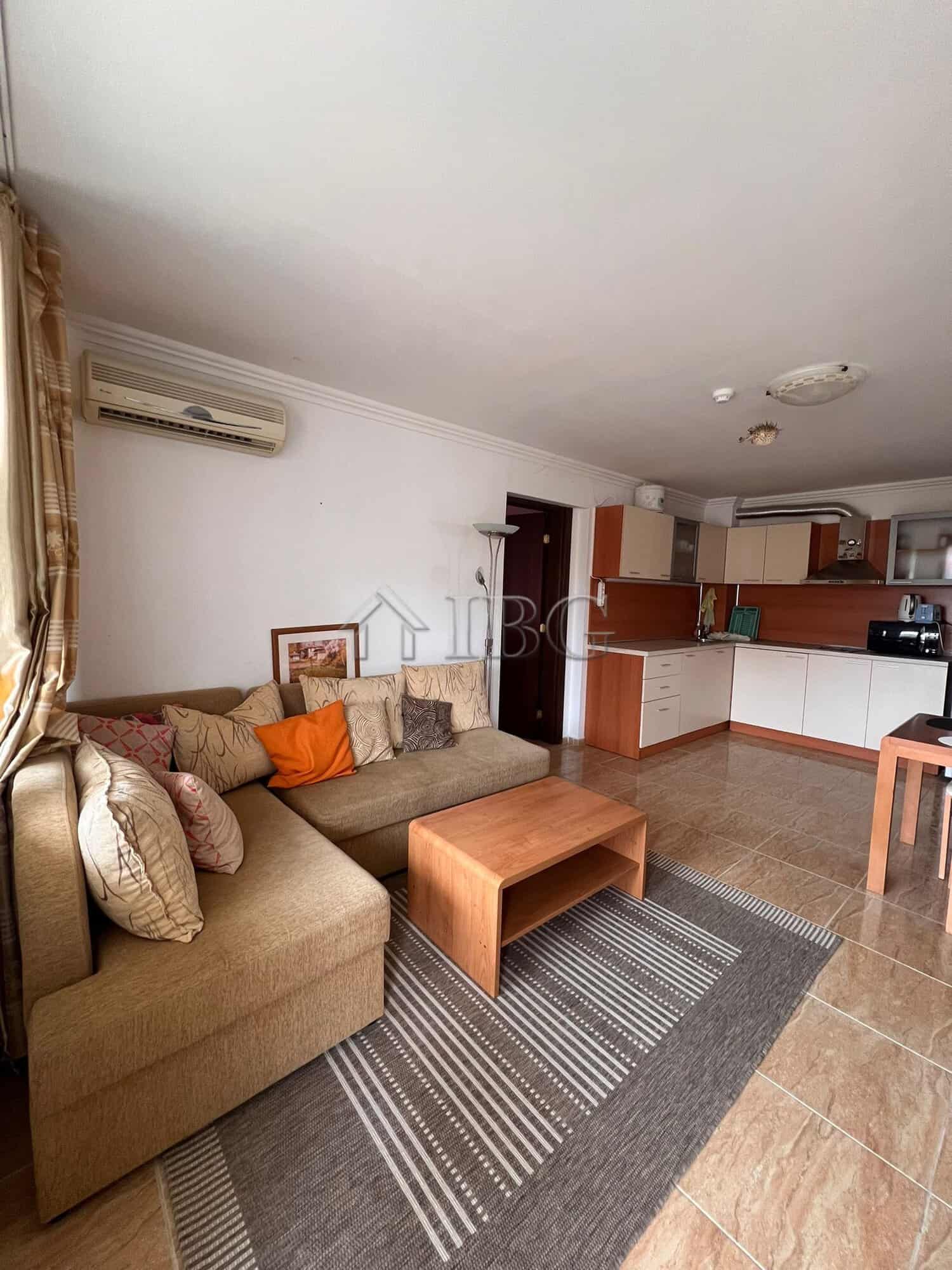 Spacious living area with sofa, cushions, and modern kitchen in Kambani 3 complex, Sveti Vlas.