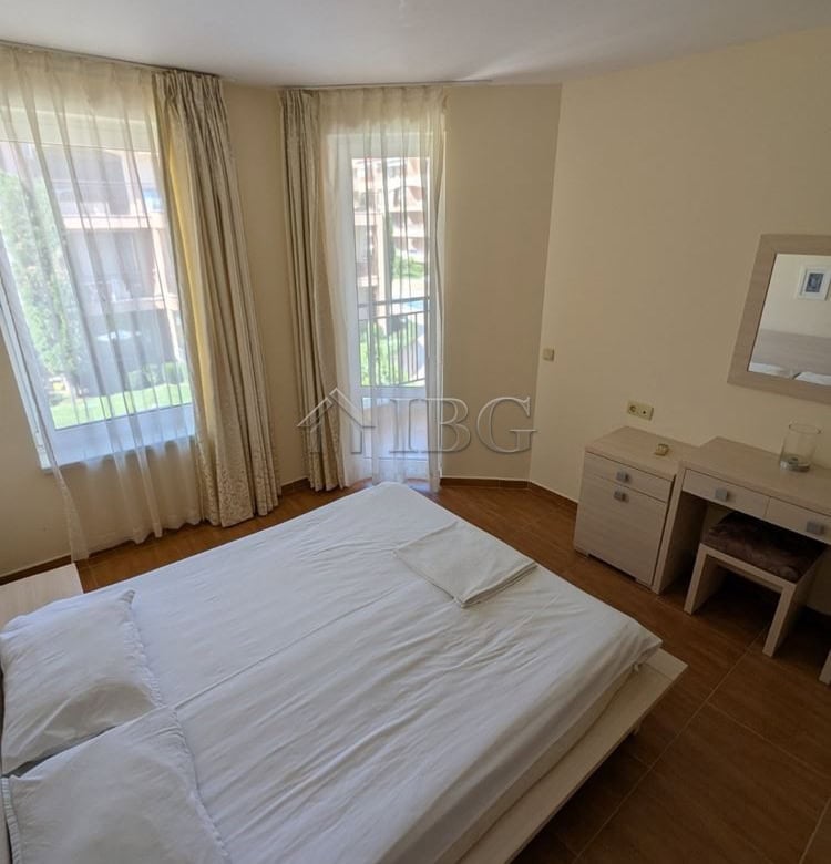 Spacious bedroom with large windows offering a pool view in Panorama Dreams, Sveti Vlas. Perfect for.